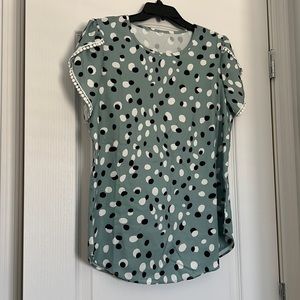 Light Green, black and white spotted shirt.
